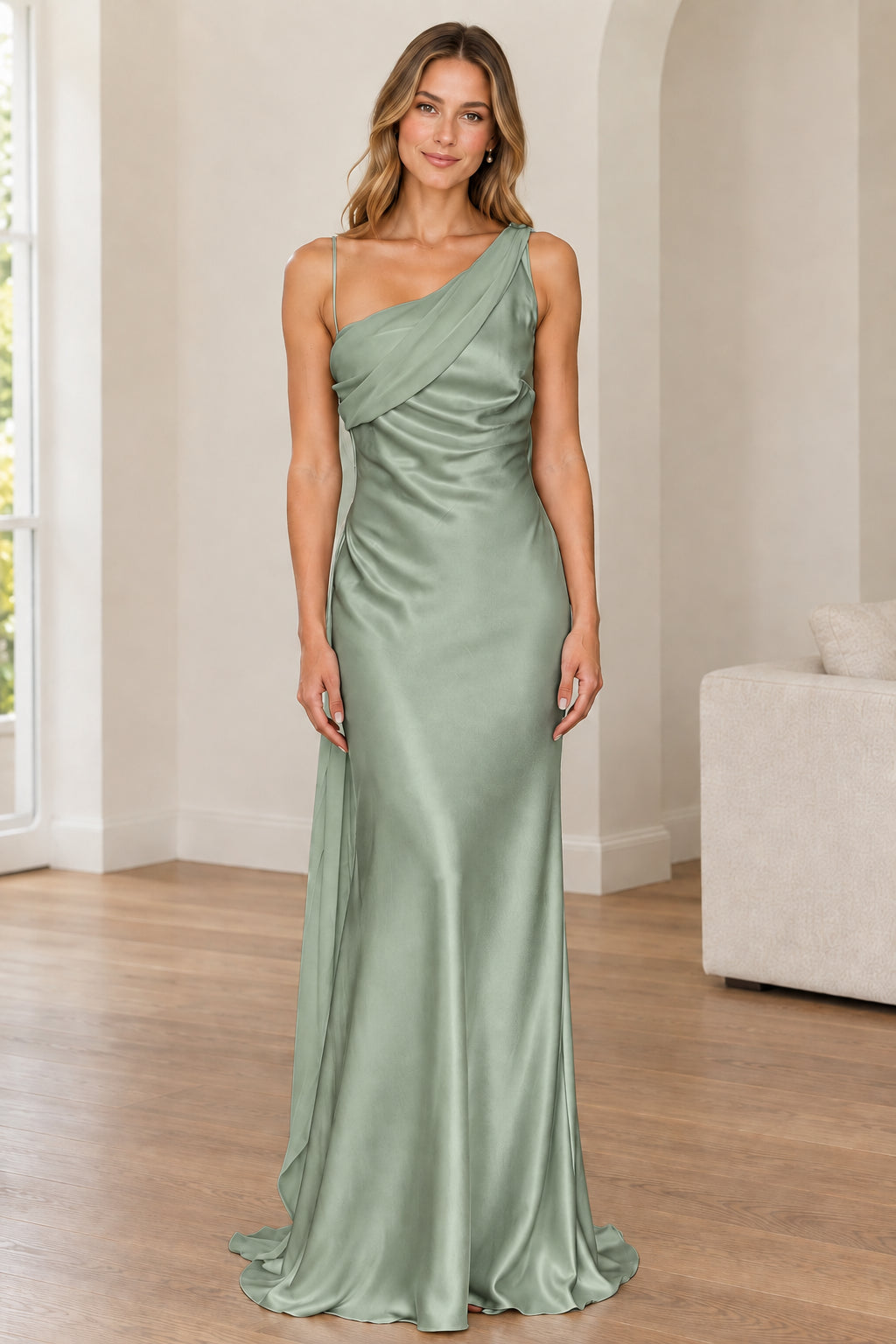 Front full-length view of woman in sage green one-shoulder satin gown