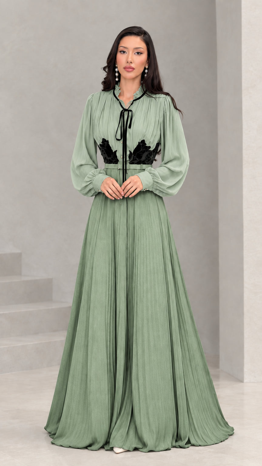 Full front view of sage green and black long sleeve pleated maxi dress