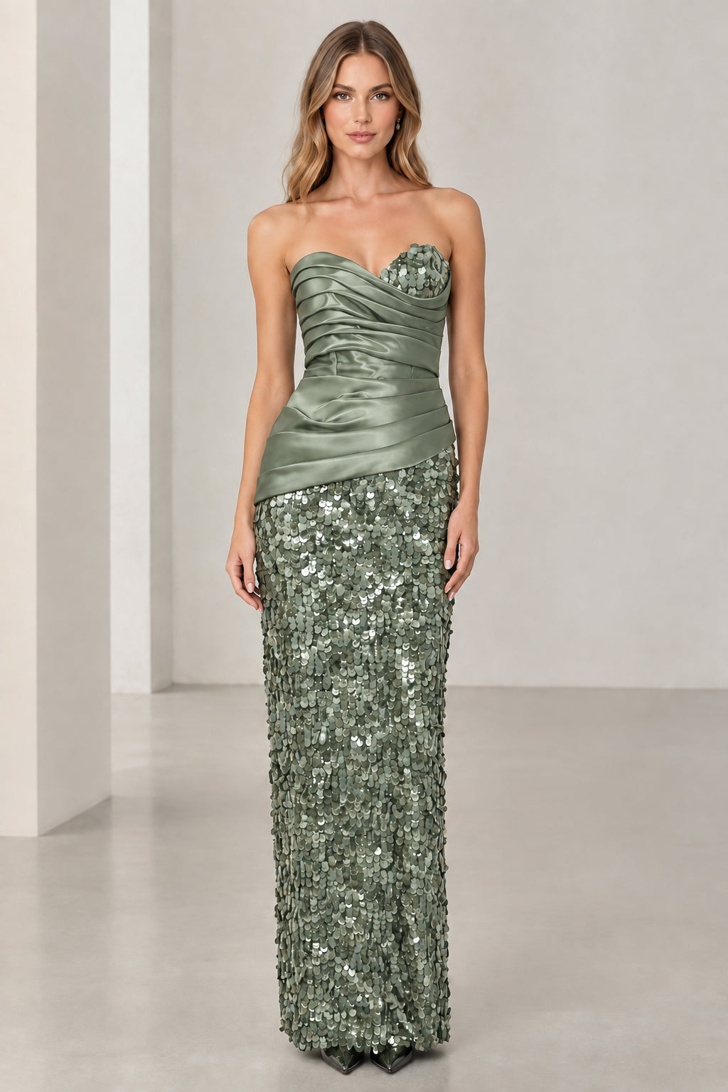 Model wearing sage green strapless ruched satin sequined formal dress