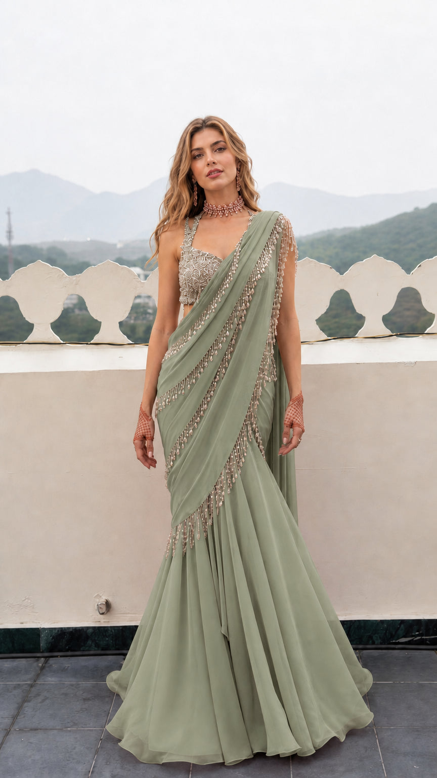 Front view of woman wearing Sage Green pre-draped mermaid saree gown with embellished blouse