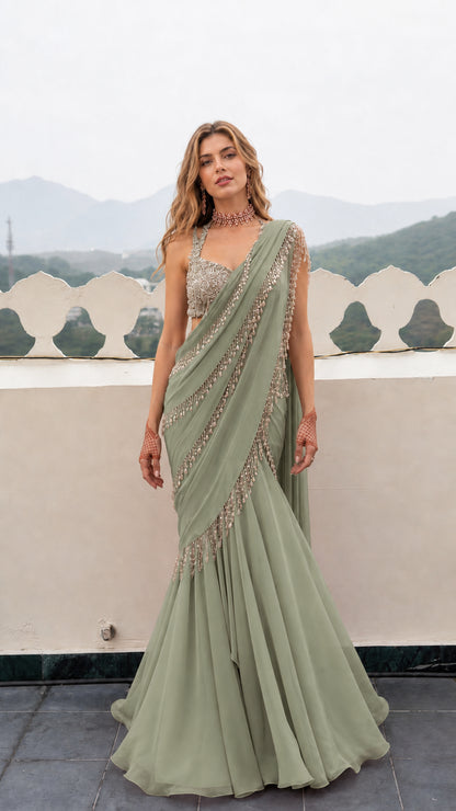 Front view of woman wearing Sage Green pre-draped mermaid saree gown with embellished blouse