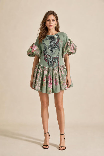 Model wearing green color variant of graphic puff sleeve mini dress