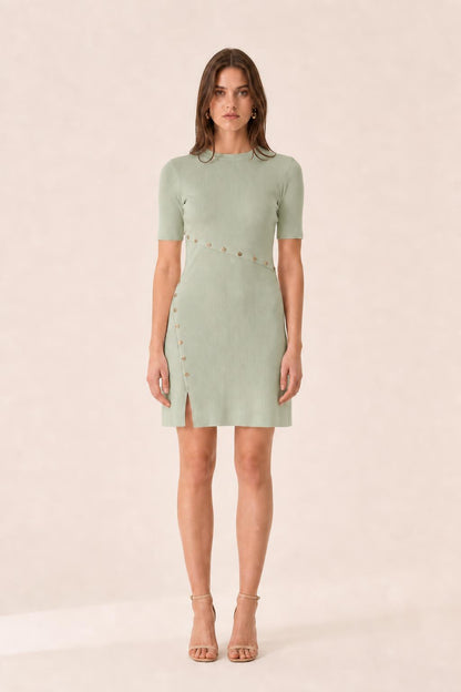 Front view of woman wearing sage green ribbed knit mini dress