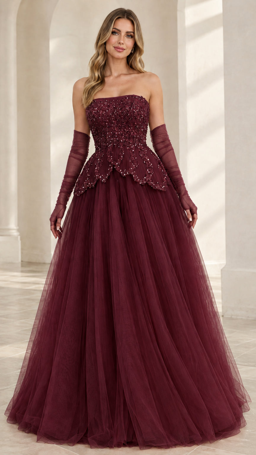 Front view of model wearing Burgundy wine strapless beaded tulle ball gown