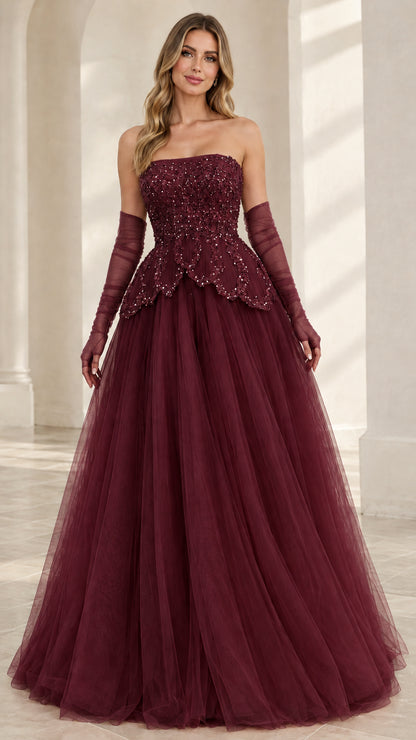 Front view of model wearing Burgundy wine strapless beaded tulle ball gown