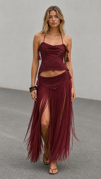 Front view of burgundy boho skirt set with flowing fringe and halter top