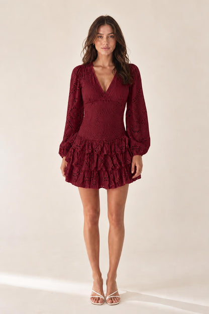 Front view of model wearing burgundy eyelet mini dress