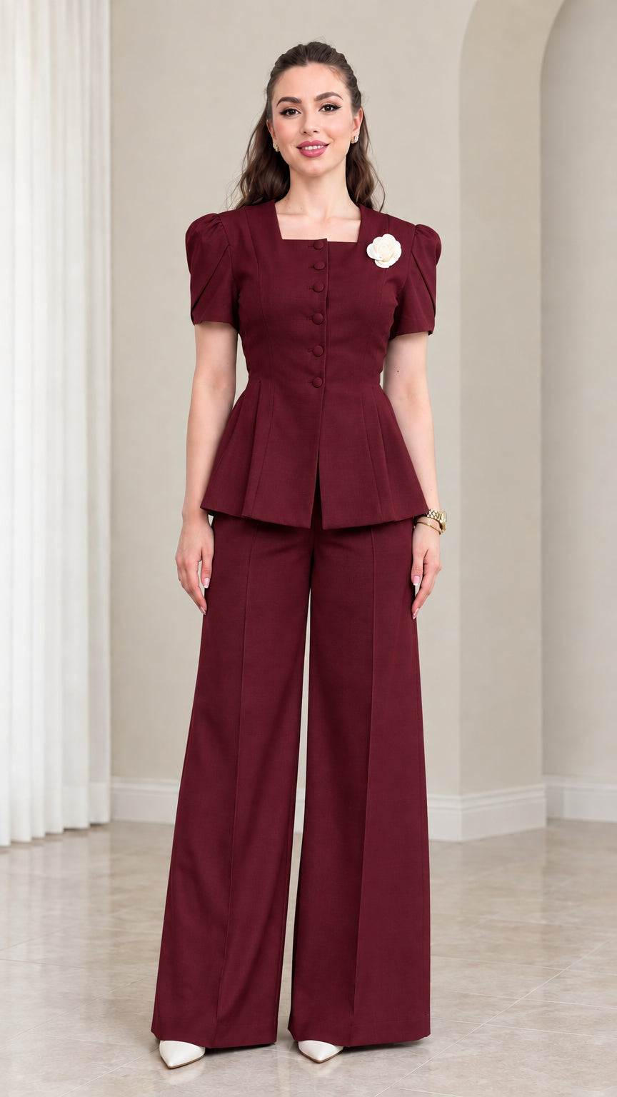 Model wearing Burgundy tailored peplum suit set with wide leg trousers