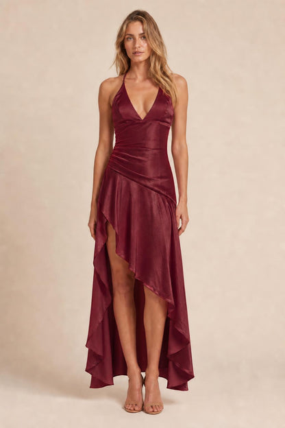 Model wearing burgundy satin halter high-low maxi dress