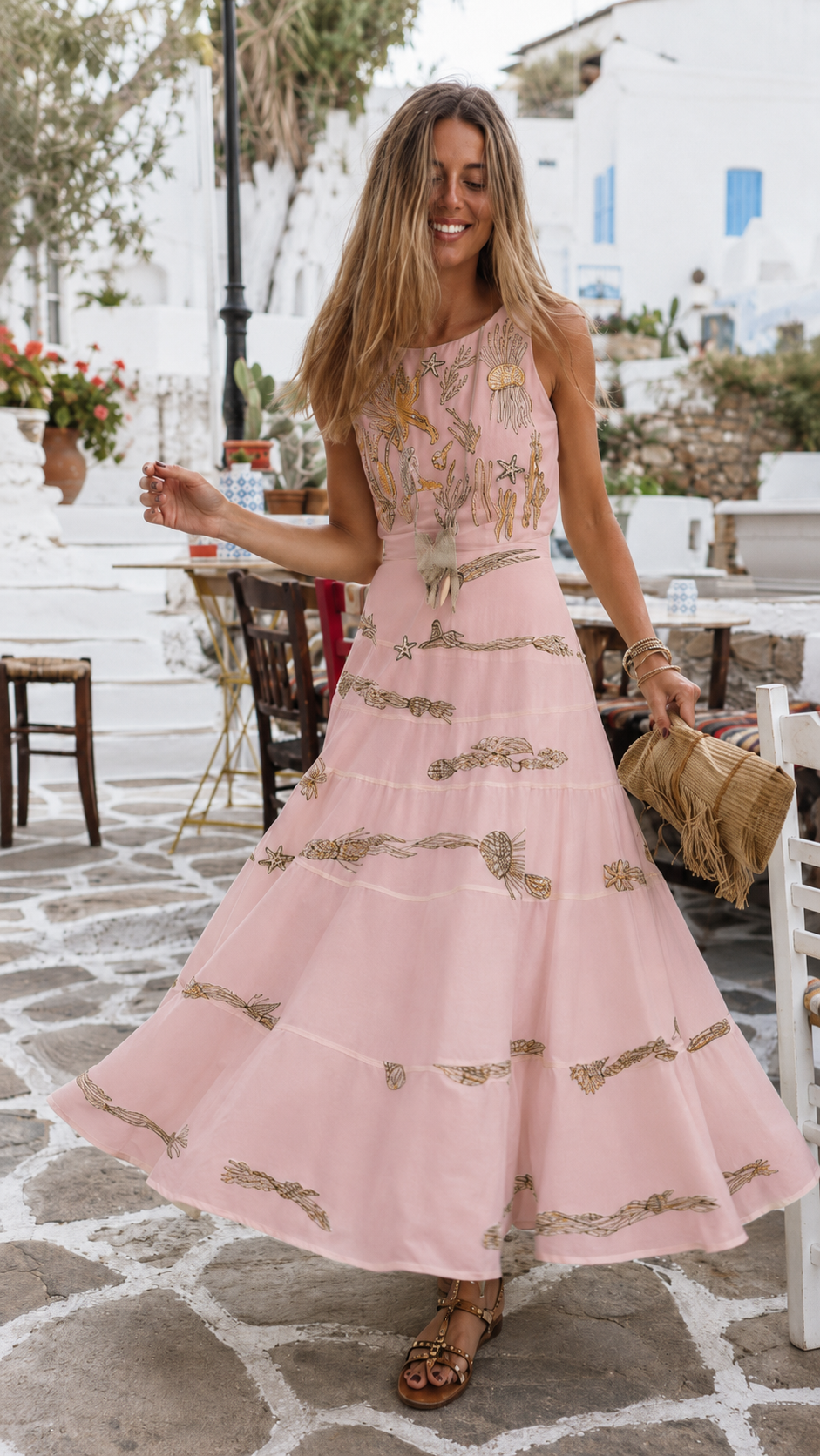 Front view of blush pink sleeveless embroidered tiered maxi dress with full-length skirt