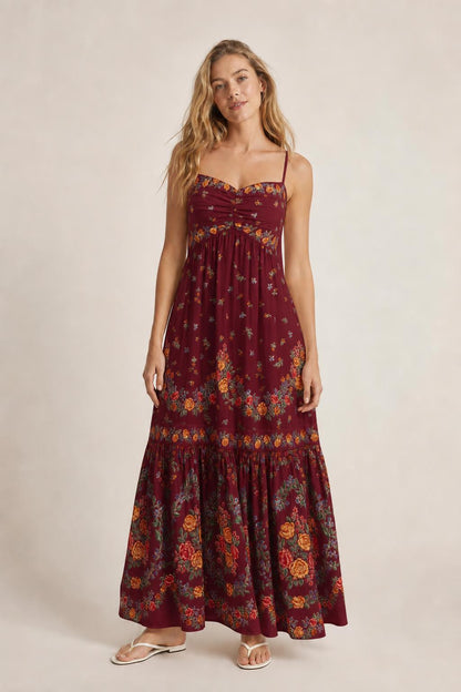 Front view of burgundy floral maxi dress on model