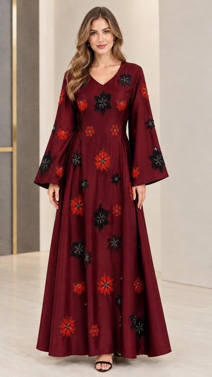 Front view of burgundy red floral embroidered maxi gown with flared sleeves
