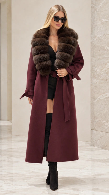 Front full view of woman wearing burgundy wine longline coat with faux fur collar