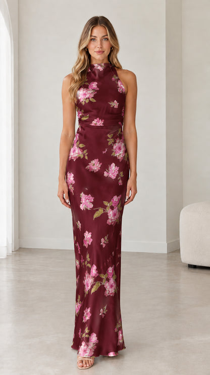 Model wearing burgundy floral satin halter open back evening gown