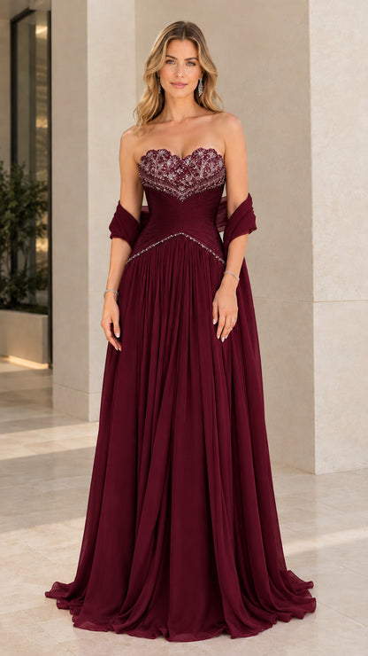 Front view of model wearing Burgundy strapless beaded pleated chiffon formal gown with shawl