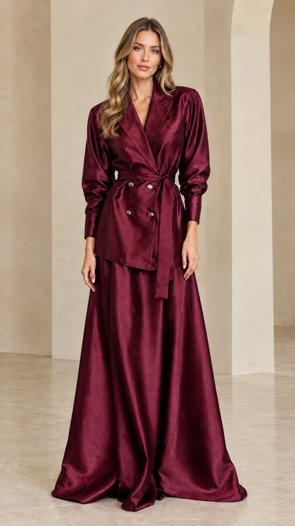 Woman wearing deep burgundy satin blazer and maxi skirt set