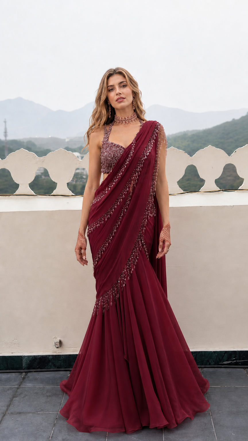 Front view of woman wearing Burgundy pre-draped mermaid saree gown with fringe trim