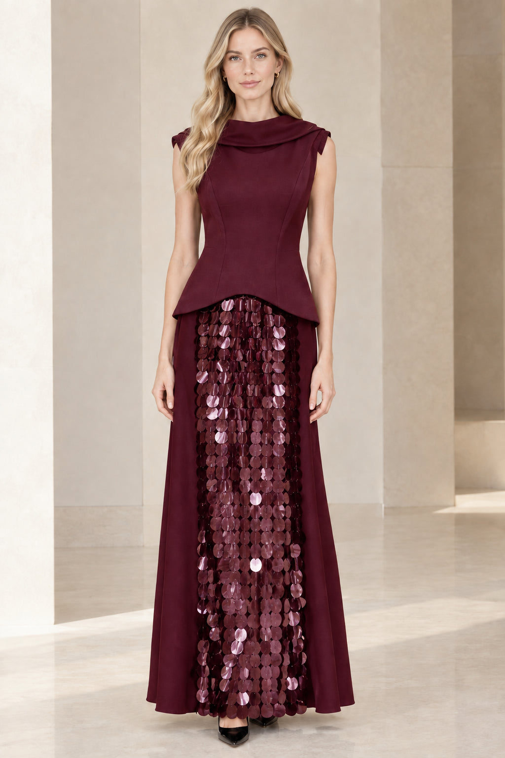 Full front view of model in burgundy wine cowl neck peplum evening gown with sequin panel