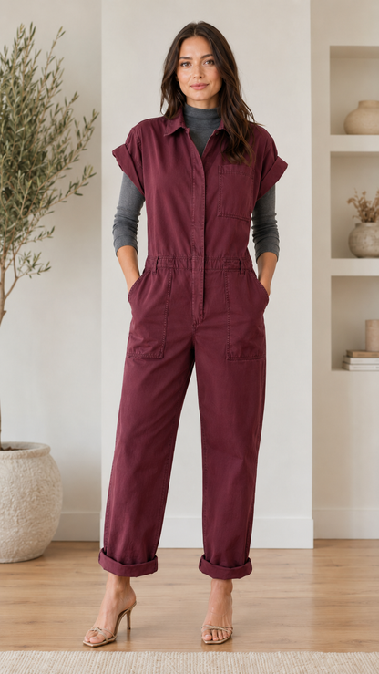 Front view of burgundy utility jumpsuit with rolled short sleeves and straight legs