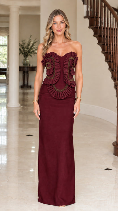 Model wearing Burgundy red strapless beaded evening gown