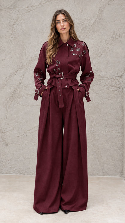 Full front view of model wearing burgundy embellished wide-leg jumpsuit