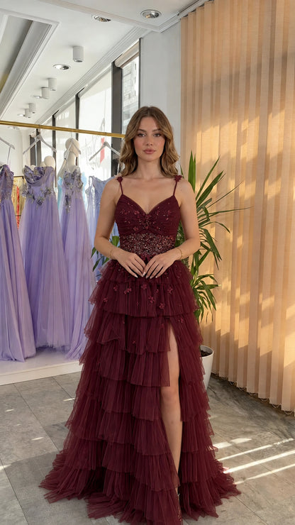 Front view of burgundy wine red tiered ruffle tulle formal gown