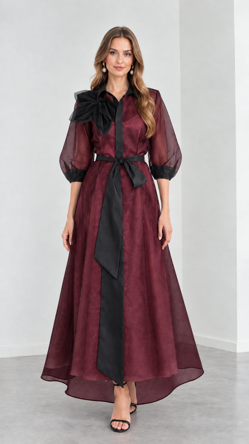Front view of model wearing rich Burgundy wine organza maxi gown with black ribbon belt