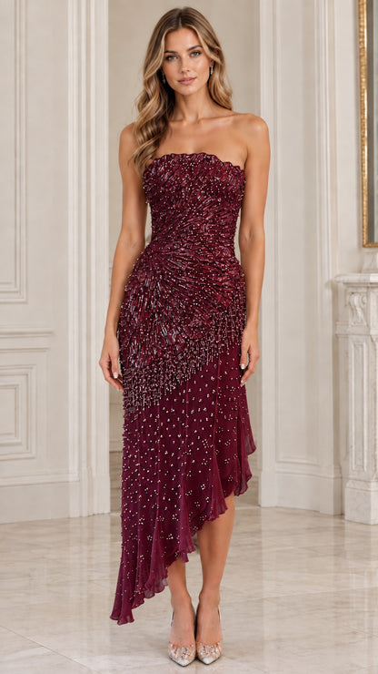Model wearing burgundy red strapless embellished asymmetric evening gown