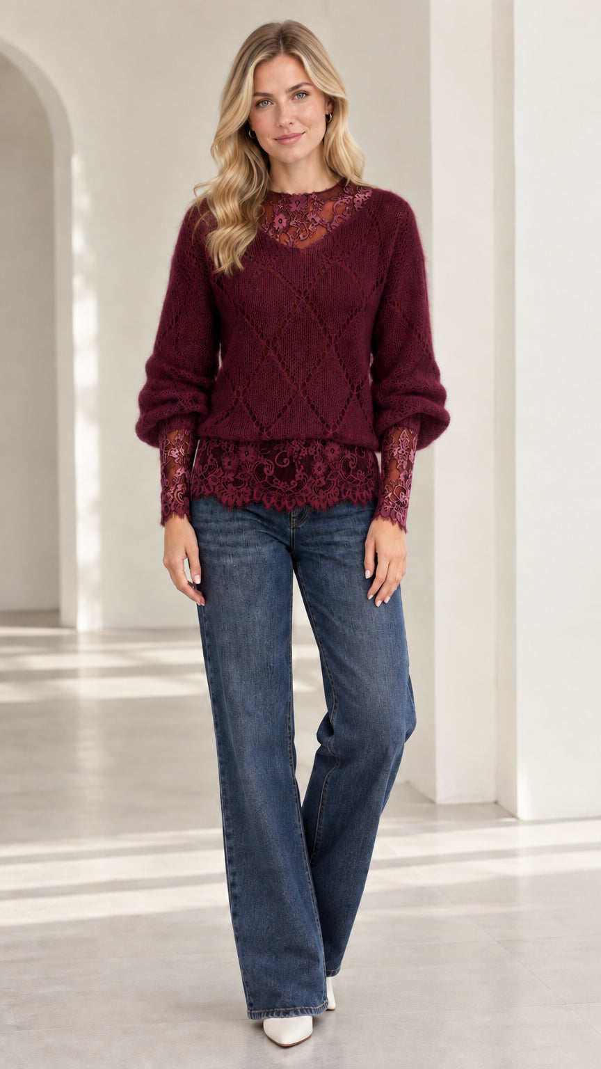 Model wearing burgundy wine red lace trim knit sweater with dark denim jeans