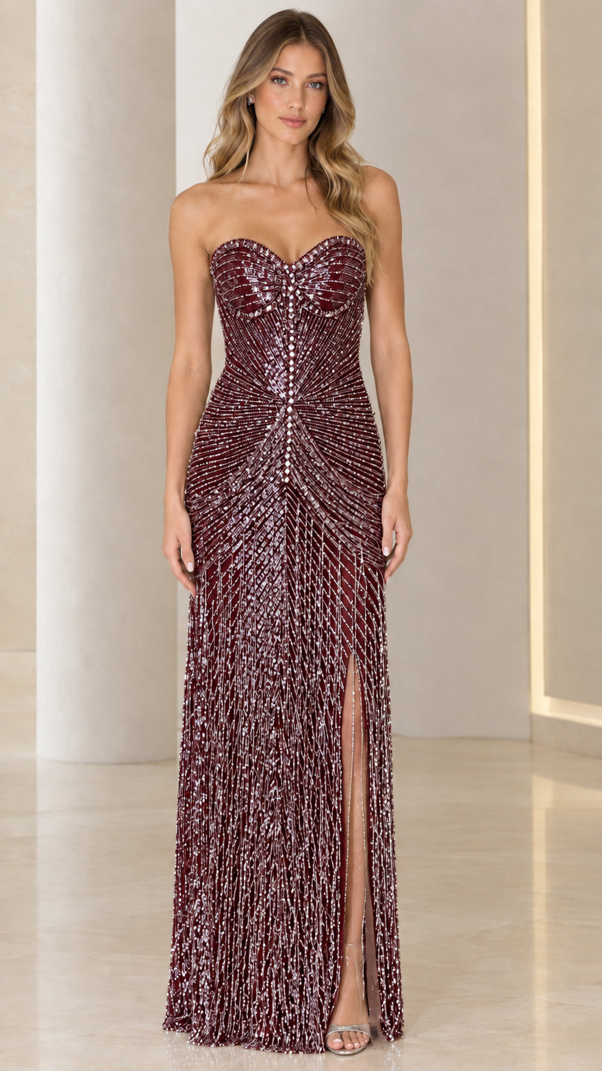 Model wearing burgundy wine strapless beaded fringe gala gown