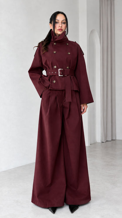 Model wearing Burgundy high-neck double-breasted trench jacket and wide-leg pant set