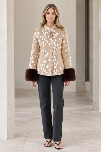 Front view of model wearing beige spotted faux fur jacket with plush cuffs