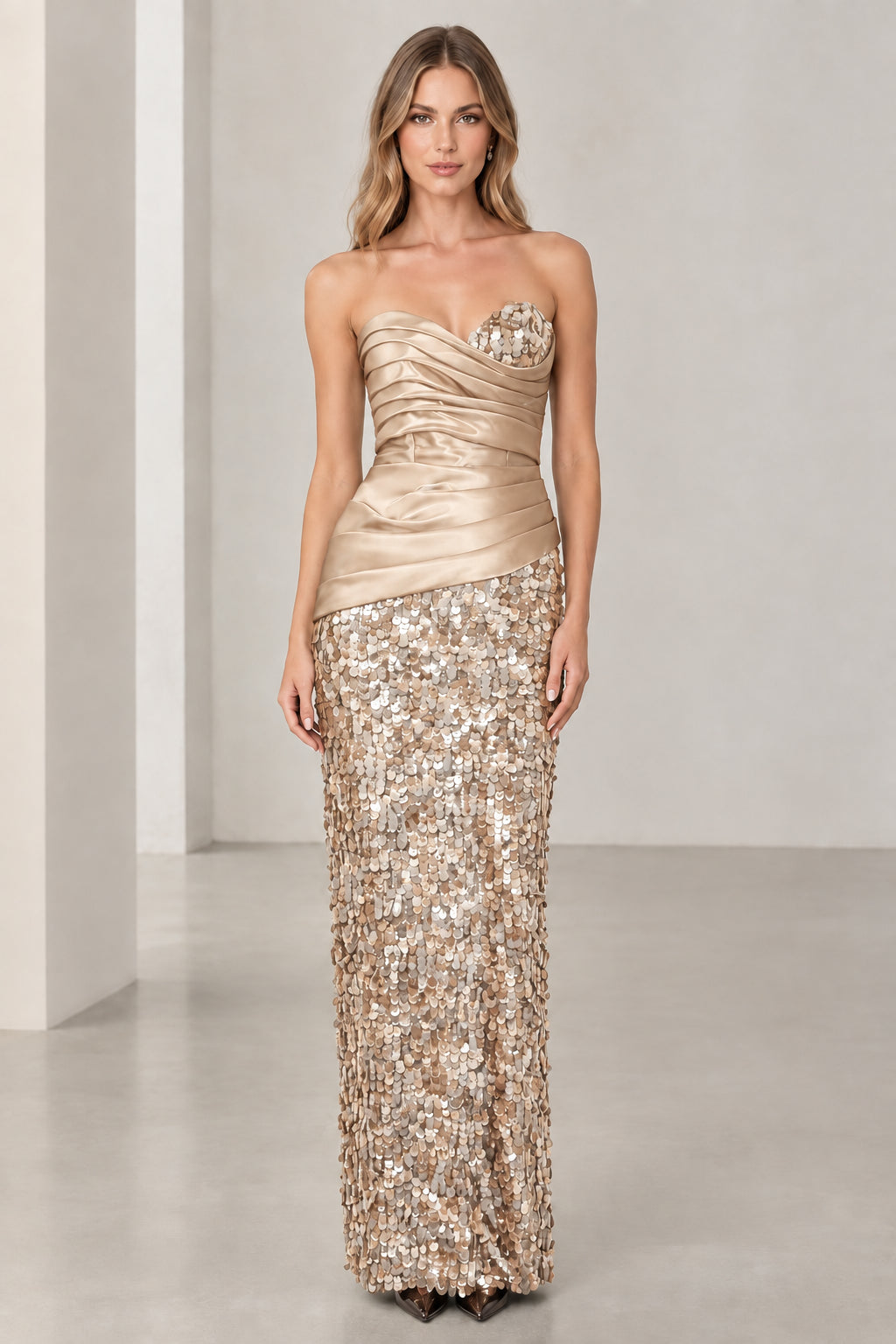 Model wearing champagne gold strapless satin and sequin evening gown