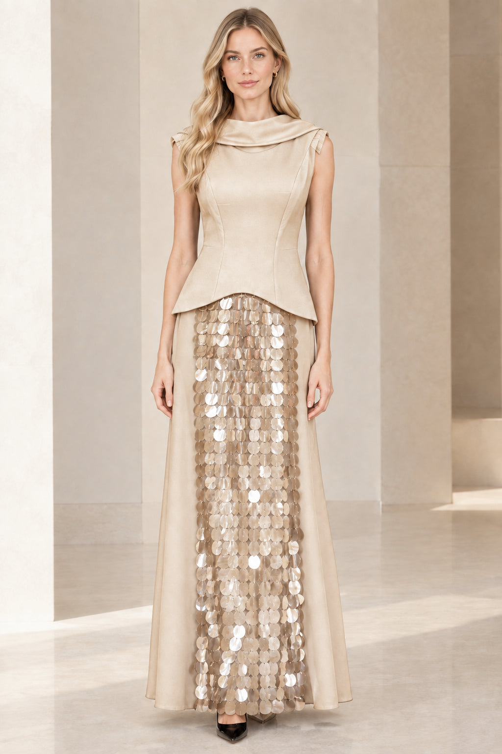 Full front view of model in champagne gold cowl neck peplum evening gown with sequin panel