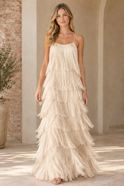 Woman wearing champagne cream tiered fringe maxi party dress