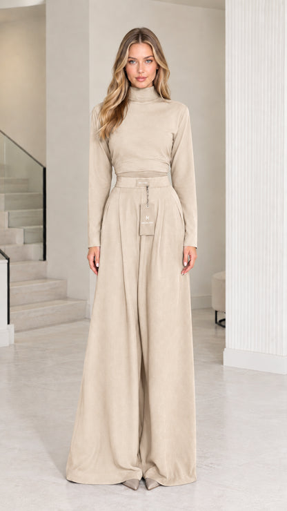 Front view of model wearing beige cream mock neck long sleeve top and palazzo pants set