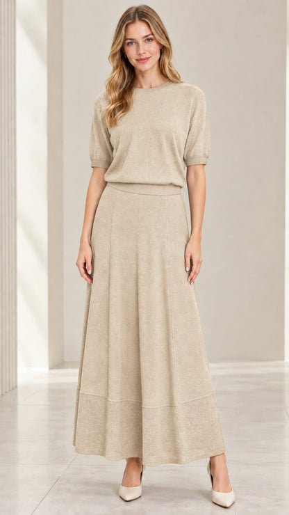 Model wearing champagne beige metallic sparkle knit top and maxi skirt set