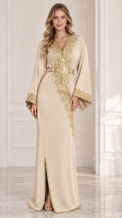 Front view of model wearing champagne beige Moroccan kaftan dress with gold embroidery and belt
