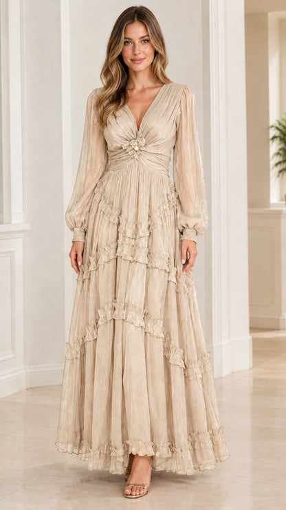 Model wearing champagne beige long sleeve tiered plissé maxi evening dress