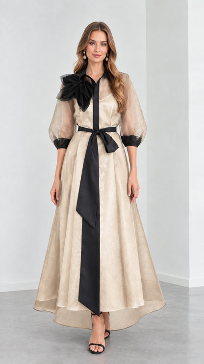 Front view of model wearing Champagne beige organza evening shirt dress with black sash