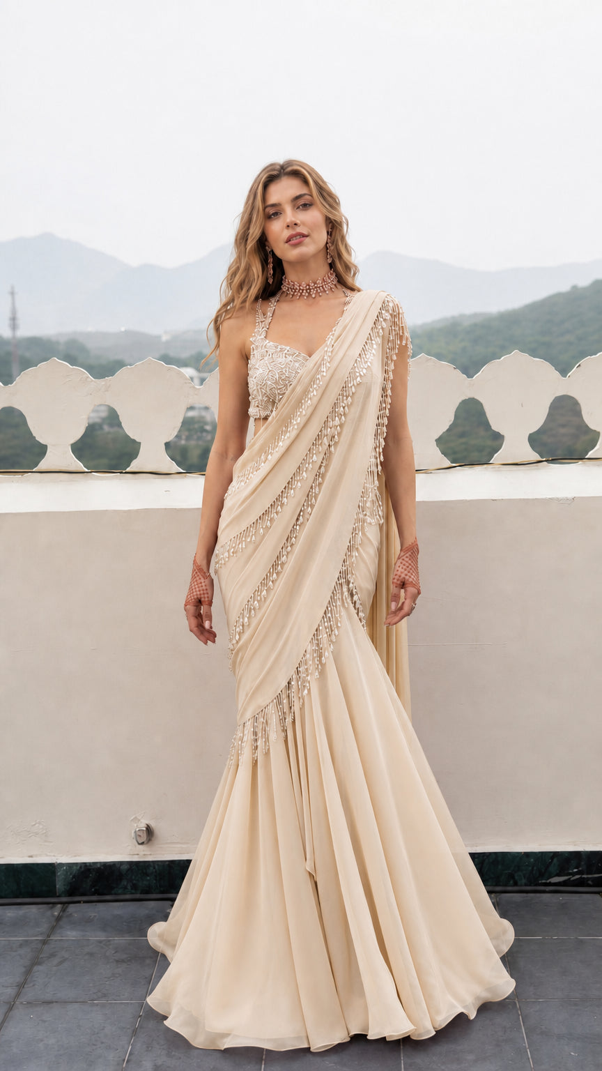 Front view of woman wearing Champagne cream pre-draped mermaid saree gown for evening wear