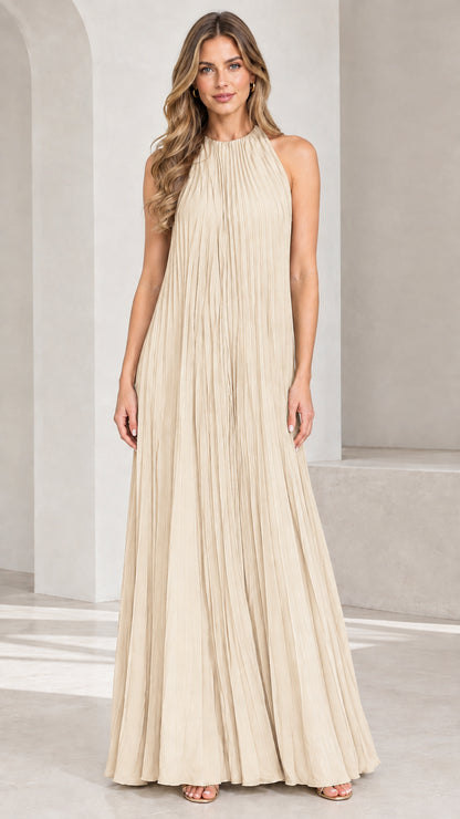 Front view of woman wearing Champagne beige pleated halter maxi dress